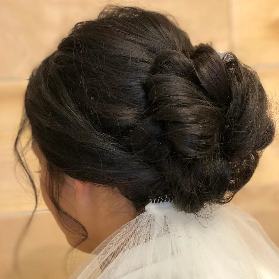 Bridal low chignon updo with a tulle veil at SALT Salon + Spa, Antioch IL