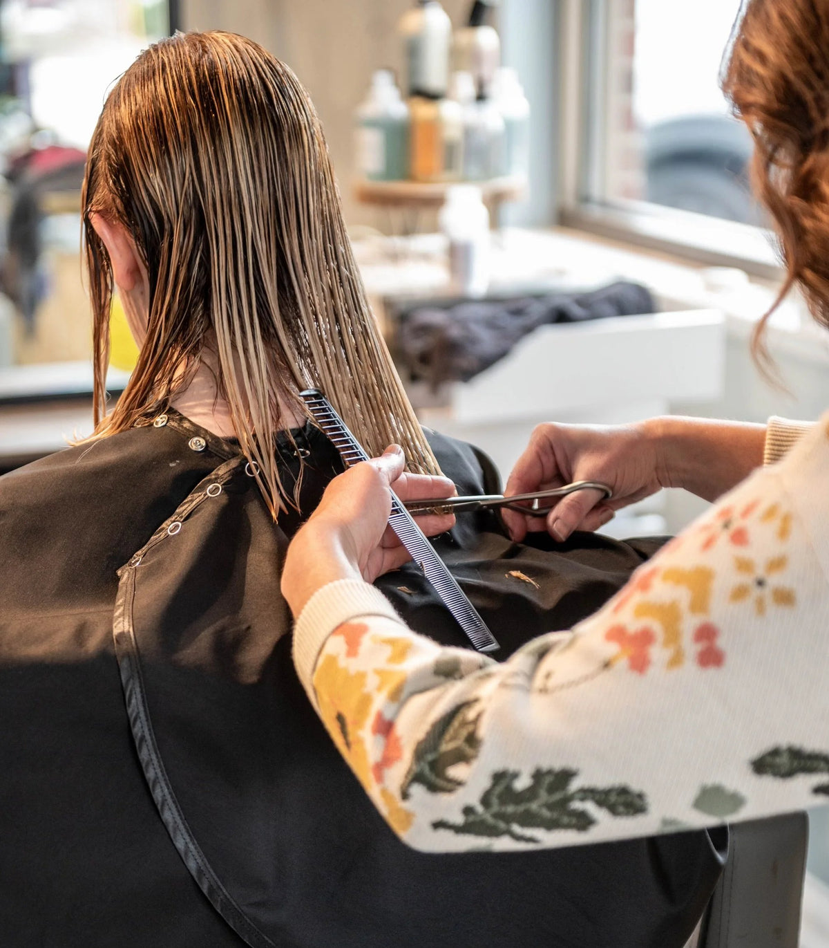 Stylist sectioning wet hair for a precision cut at SALT Salon + Spa, Antioch IL